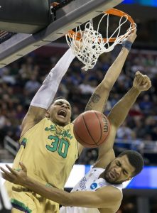 The Notre Dame's Zach Auguste (30) dunks the ball over Kentucky's Andrew Harrison (5) in the second half Saturday, March 28, 2015, in Cleveland. SBT Photo/BECKY MALEWITZ